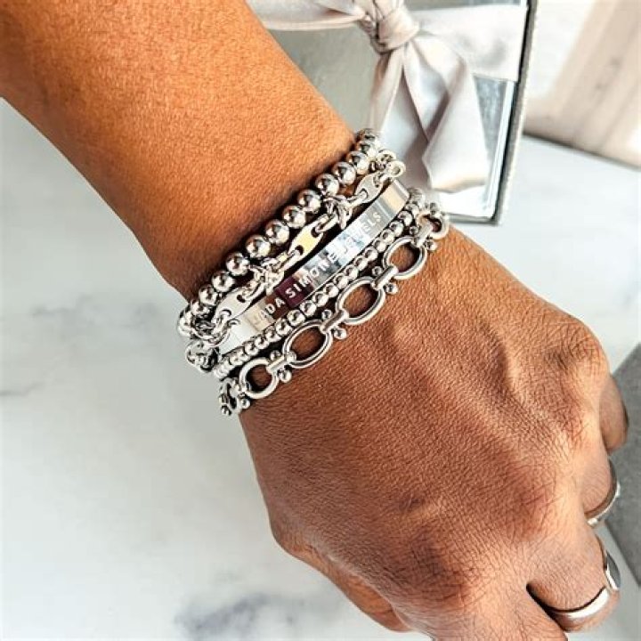 Stacked metal bracelets and festival accessories