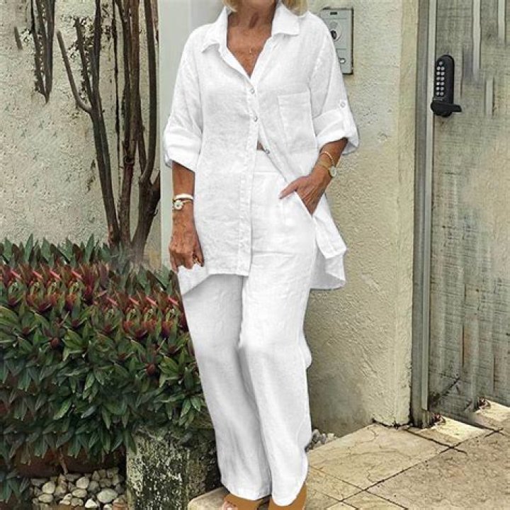 Woman in stylish linen summer outfit at a park